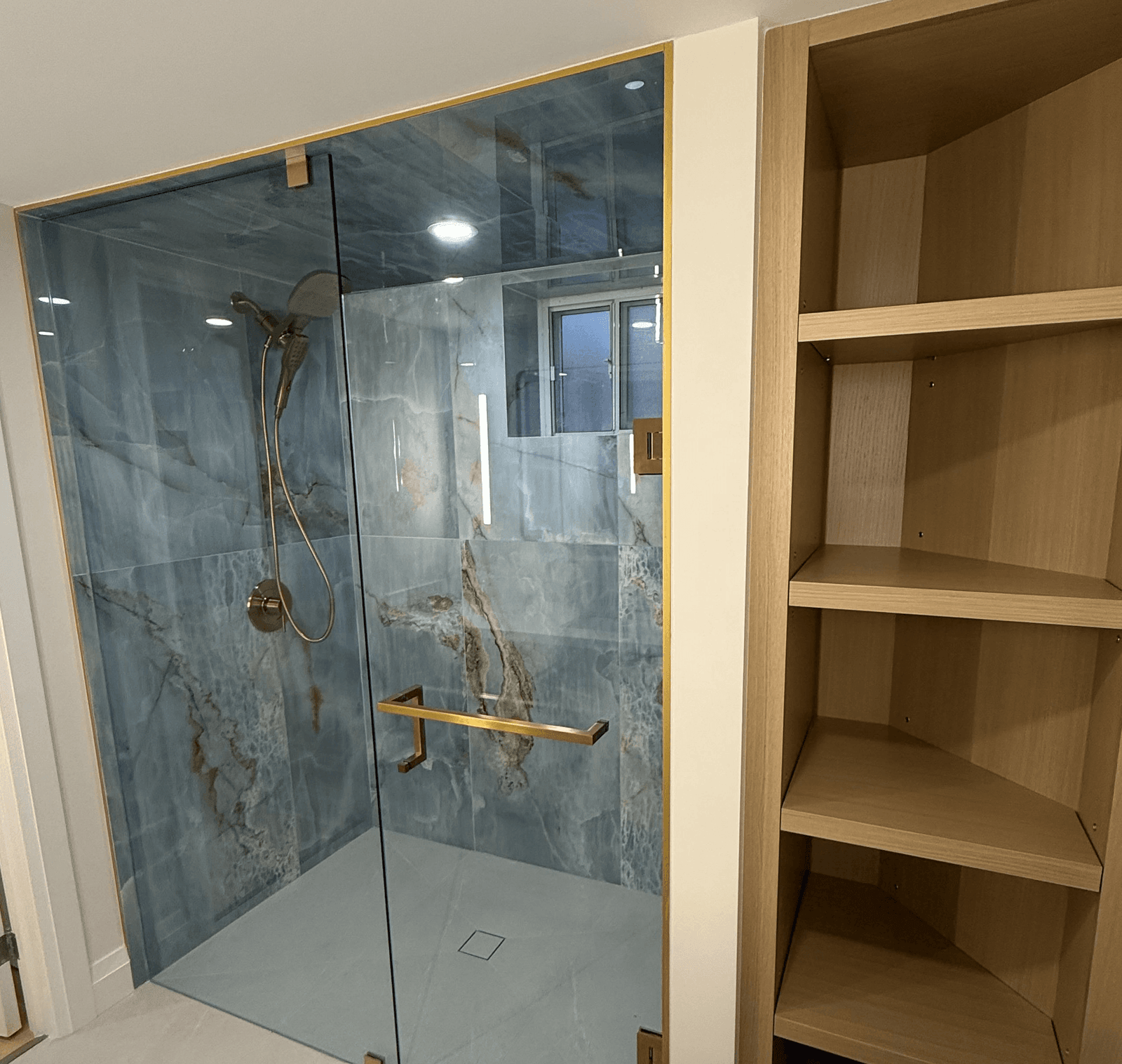 Spa bathroom with blue stone tile and glass shower