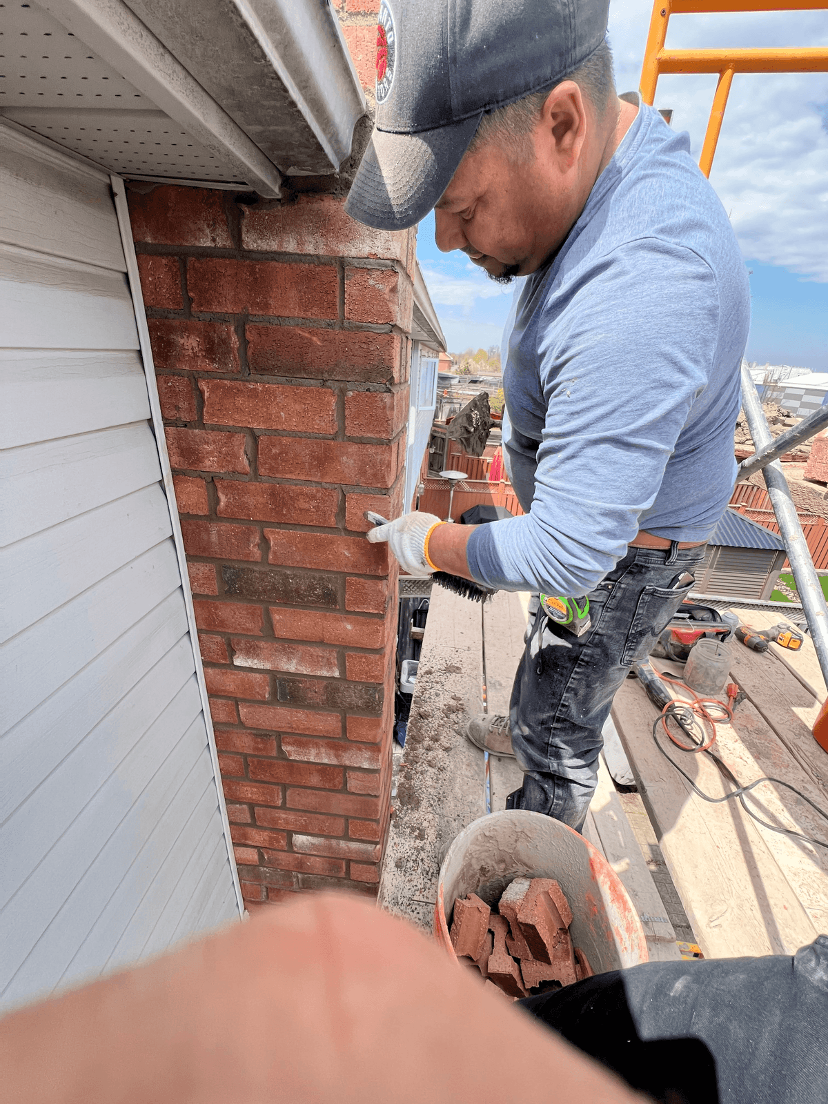 Mason laying new brickwork on a home exterior